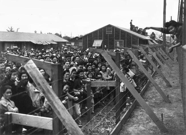 Japanese women behind barbed wire at an internment camp