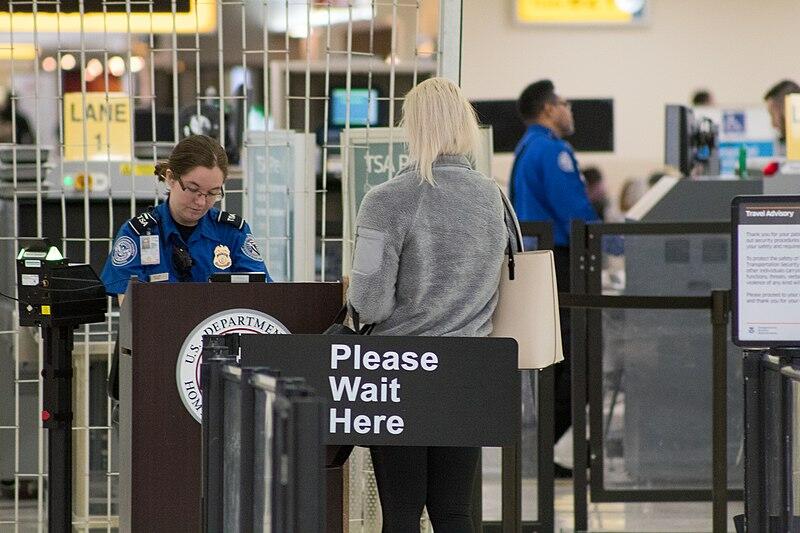 Guest stands at an airport security checkpoint
