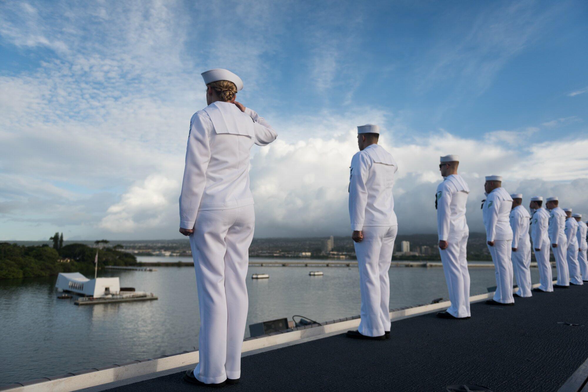 Sailors salute the USS Arizona Memorial on the 75th Anniversary of the Pearl Harbor attack.