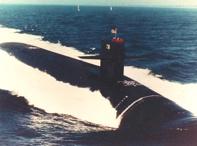 The submarine USS West Virginia steaming ahead on the ocean's surface.